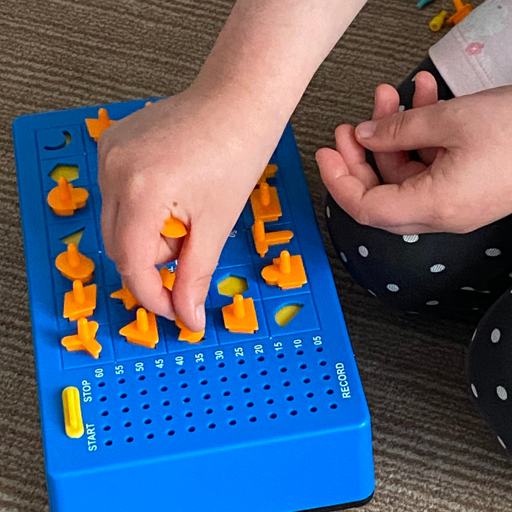 Hands using a visual problem-solving game.