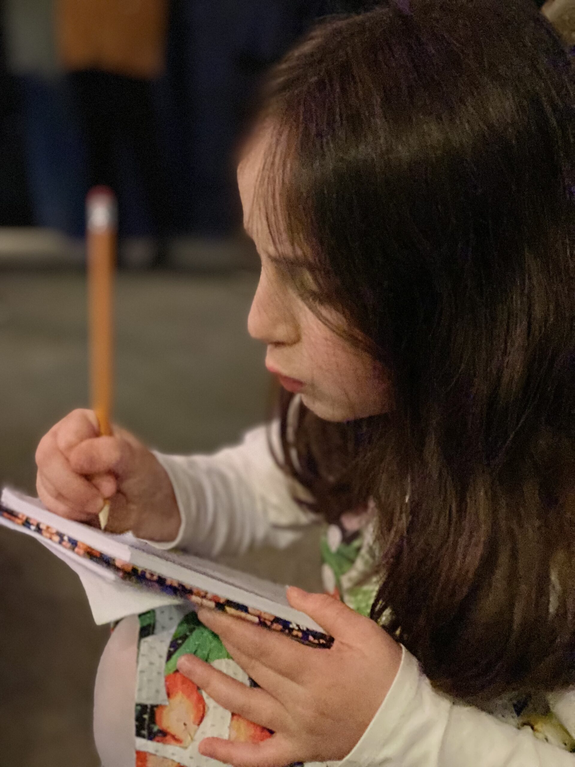 A child writing during a personalised tutoring session.